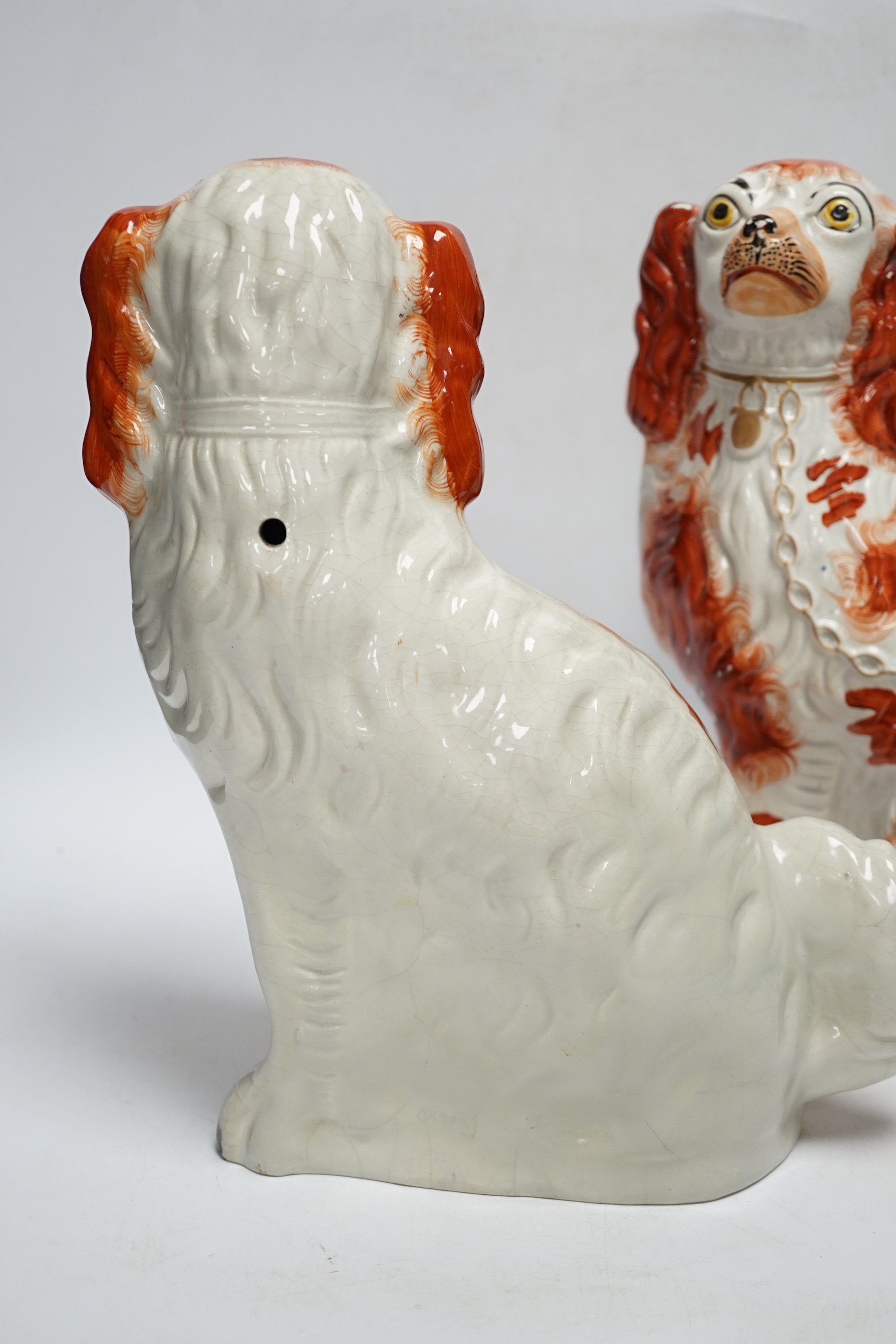 A Royal Worcester classical revival glazed Parian vase and two Staffordshire dogs, 30cm